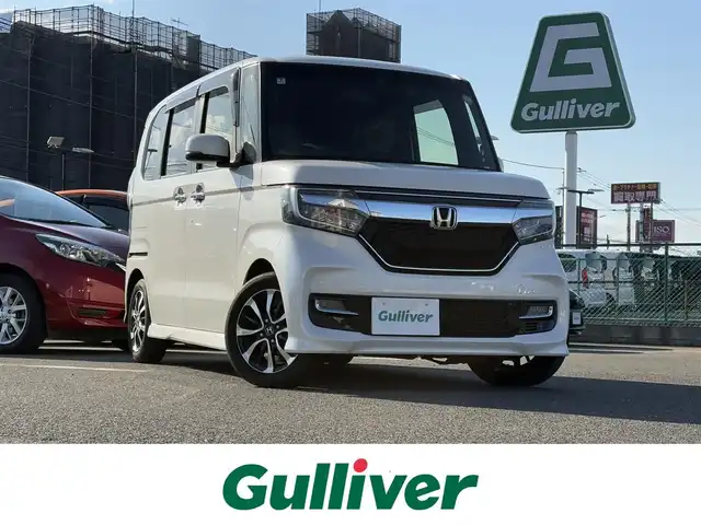 ホンダ Ｎ ＢＯＸ カスタム G L ホンダセンシング 大分県 2018(平30)年 6.7万km プレミアムホワイトパールⅡ ・純正メモリナビ/・Bluetooth/・フルセグTV/・バックカメラ/・ステアリングスイッチ/・両側パワースライドドア/・クルーズコントロール/・衝突軽減ブレーキ/・横滑り防止装置/・レーンキープアシスト/・スマートキー＆プッシュスタート/・LEDヘッドライト＆LEDフォグライト/・オートライト/・純正前方録画タイプドライブレコーダー/・純正14インチAW/・保証書・取説/・スペアキー1個