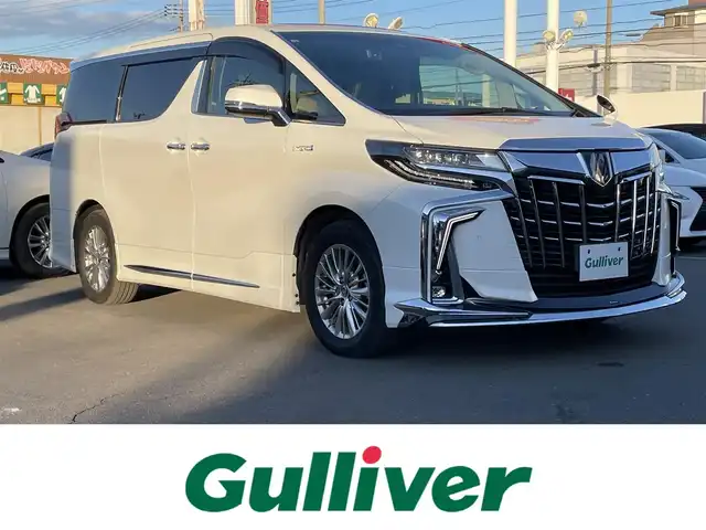 トヨタ アルファードハイブリット SR Cパッケージ 群馬県 2019(令1)年 3.9万km ホワイトパールクリスタルシャイン 4WD/ツインムーンルーフ/モデリスタエアロ(F/S/R)/シグネチャーイルミブレード/純正10型ナビ/CD・DVD・SD/Bluetooth・フルセグ/バックカメラ/両側パワースライドドア/デジタルインナーミラー/ビルトインETC2.0/レザーシート・パワーシート/シートヒーター・ベンチレーション/2列目エグゼグティブパワーシート/ステアリングヒーター/追従クルーズコントロール/AC100V1500W/三眼LEDヘッドライト/シーケンシャルターンランプ/横滑り防止装置/レーンキープアシスト/衝突軽減ブレーキ/アイドリングストップ/純正アルミホイール/純正フロアマット/Grgoセキュリティ/取説・保証書/スマートキー×2