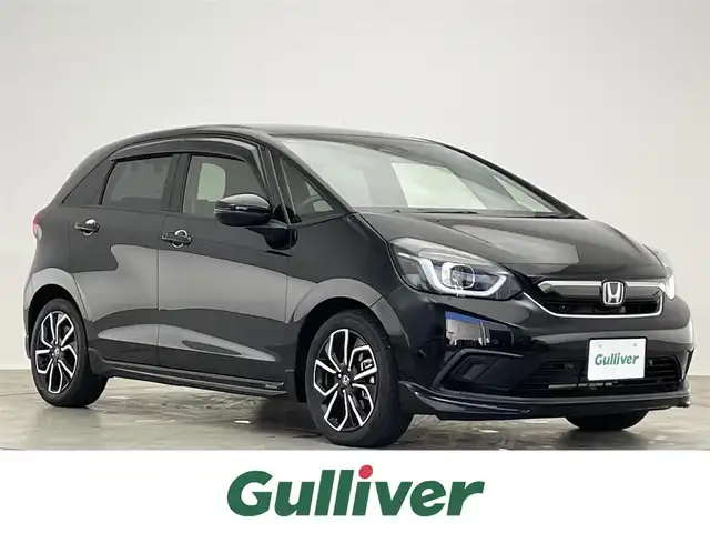 ホンダ フィット e:HEVホーム 滋賀県 2021(令3)年 3.4万km クリスタルブラックパール 禁煙車/純正ナビ/（CD/DVD/SD/Bluetooth/フルセグTV）/バックカメラ/ミラー型前後ドライブレコーダー/ビルトインETC/路外逸脱抑制機能/踏み間違い衝突軽減システム/先行車発進お知らせ/レーンキープアシストシステム/標識認識機能/革巻きステアリング/アダプティブクルーズコントロール/ステアリングリモコン/電動パーキングブレーキ/オートブレーキホールド/USB充電/ハーフレザーシート/LEDヘッドライト/オートヘッドライト/純正アルミホイール/社外フロアマット/スペアキー