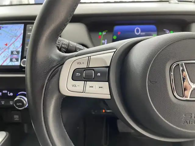 ホンダ フィット e:HEVホーム 滋賀県 2021(令3)年 3.4万km クリスタルブラックパール 禁煙車/純正ナビ/（CD/DVD/SD/Bluetooth/フルセグTV）/バックカメラ/ミラー型前後ドライブレコーダー/ビルトインETC/路外逸脱抑制機能/踏み間違い衝突軽減システム/先行車発進お知らせ/レーンキープアシストシステム/標識認識機能/革巻きステアリング/アダプティブクルーズコントロール/ステアリングリモコン/電動パーキングブレーキ/オートブレーキホールド/USB充電/ハーフレザーシート/LEDヘッドライト/オートヘッドライト/純正アルミホイール/社外フロアマット/スペアキー