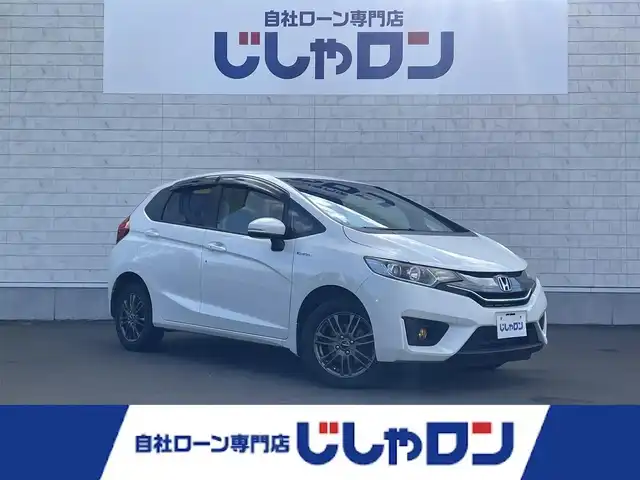 ホンダ フィット ハイブリット Lパッケージ 道北・旭川 2015(平27)年 8.9万km ホワイトオーキッドパール (株)IDOMが運営する【じしゃロン旭川店】の自社ローン専用車両になります。こちらは現金またはオートローンご利用時の価格です。自社ローンご希望の方は別途その旨お申付け下さい・/　/・純正ナビ(CD/DVD/BT/SD/フルセグ)/・バックカメラ/・ETC/・レーダーブレーキ/・クルーズコントロール/・ステアリングリモコン/・プッシュスタート/・スマートキー2個/・フォグランプ/・取扱説明書