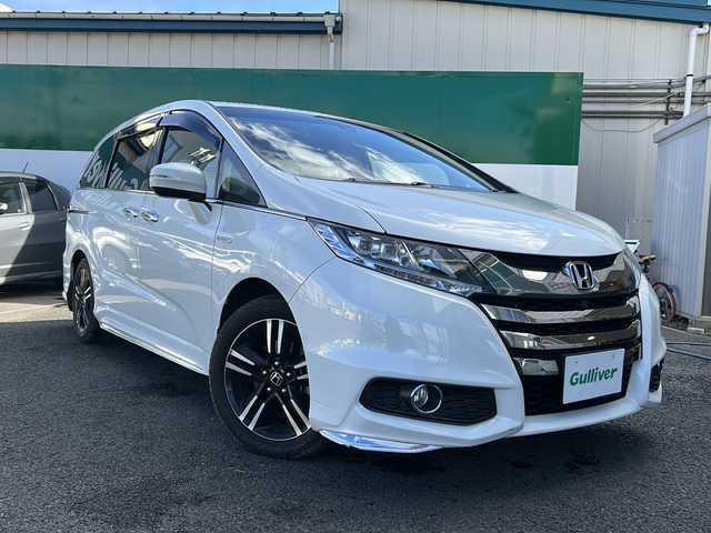 ホンダ オデッセイ ハイブリッド 福島県 2017(平29)年 8.5万km ホワイトオーキッドパール 純正ナビ　/(CD/DVD/BT/フルセグTV)/HDMI/純正フリップダウンモニター/全周囲カメラ/バックカメラ/両側パワースライドドア/クルーズコントロール追従あり/ホンダセンシング/前方ドライブレコーダー/Ｄ席パワーシート/Ｄ席Ｎ席シートヒーター/レザーシート/ビルトインＥＴＣ/純正17インチアルミホイール/LEDヘッドライト