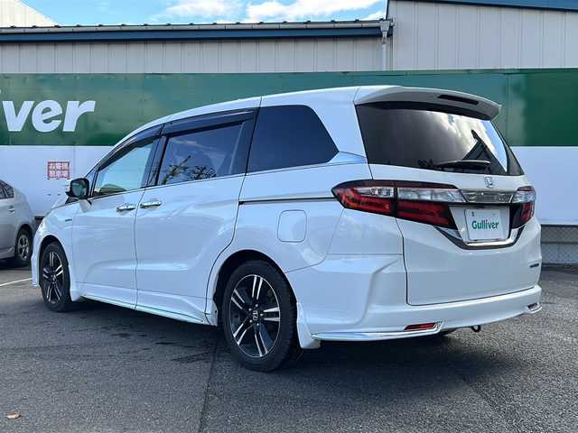 ホンダ オデッセイ ハイブリッド 福島県 2017(平29)年 8.5万km ホワイトオーキッドパール 純正ナビ　/(CD/DVD/BT/フルセグTV)/HDMI/純正フリップダウンモニター/全周囲カメラ/バックカメラ/両側パワースライドドア/クルーズコントロール追従あり/ホンダセンシング/前方ドライブレコーダー/Ｄ席パワーシート/Ｄ席Ｎ席シートヒーター/レザーシート/ビルトインＥＴＣ/純正17インチアルミホイール/LEDヘッドライト