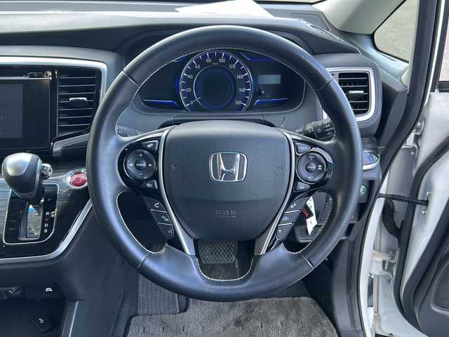 ホンダ オデッセイ ハイブリッド 福島県 2017(平29)年 8.5万km ホワイトオーキッドパール 純正ナビ　/(CD/DVD/BT/フルセグTV)/HDMI/純正フリップダウンモニター/全周囲カメラ/バックカメラ/両側パワースライドドア/クルーズコントロール追従あり/ホンダセンシング/前方ドライブレコーダー/Ｄ席パワーシート/Ｄ席Ｎ席シートヒーター/レザーシート/ビルトインＥＴＣ/純正17インチアルミホイール/LEDヘッドライト