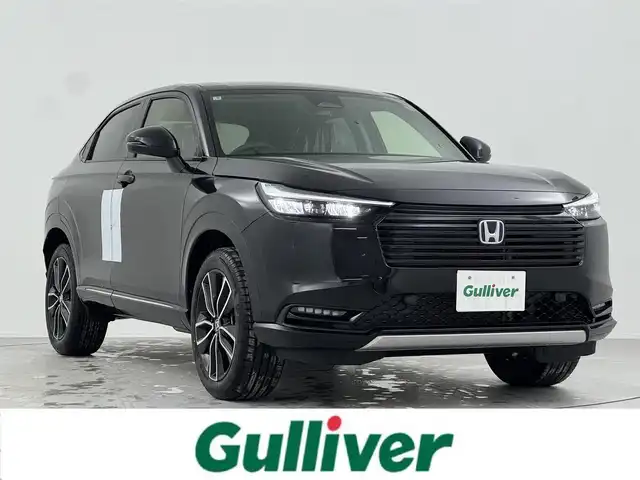 ホンダ ヴェゼル ハイブリッド e:HEV Z 熊本県 2025(令7)年 0.1千km クリスタルブラックパール 登録済未使用車　/純正ナビ/・Apple Car Play/AndroidAuto/フルセグTV/BT/USB/・バックカメラ/ホンダセンシング/・衝突軽減ブレーキ/・誤発進抑制機能/・後方誤発進抑制機能/・近距離衝突軽減ブレーキ/・歩行者事故低減ステアリング/・路外逸脱制御機能/・アダブティブクルーズコントロール/・渋滞運転支援機能/・先行車発進お知らせ/・標識認識システム/・ブラインドスポットモニター/・車線維持支援システム/・オートハイビーム/コーナーセンサー/ビルトインETC2.0/ハーフレザーシート/・D/Nシートヒーター　　/ダウンヒルアシスト/パワーバックドア/ステアリングヒーター/置くだけ充電/純正１８インチAW/オートライト/LEDヘッドライト/スマートキー/プッシュスタート/スペアキー1本/保証書/取扱説明書