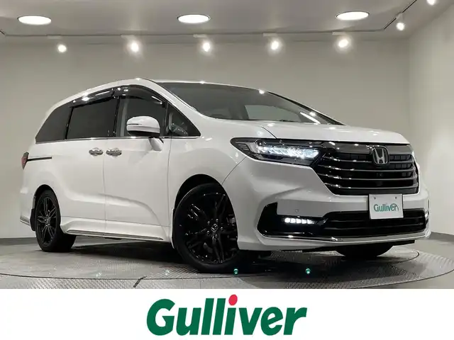 ホンダ オデッセイ ハイブリッド e:HEVアブソルート EX 愛知県 2021(令3)年 4.2万km プラチナホワイトパール 純正９インチナビ　/純正フリップダウンモニター　/ＡＣ１００Ｖ　/アラウンドビューモニター　/ホンダセンシング　/　　-衝突軽減ブレーキ/　　-レーダークルーズコントロール　/　　-車線逸脱警報/　　-誤発進抑制機能/　　-オートハイビーム/　　-コ-ーナーセンサー/　　-車線維持支援システム/　　-先行車発進お知らせ機能/　　-標識認識機能/両側パワースライドドア　/シートヒーター　/ブラインドスポットモニター　/電動バックドア　/ドライブレコーダー/ＬＥＤヘッドライト/LEDフォグランプ/パワーシート/オットマン/純正フロアマット
