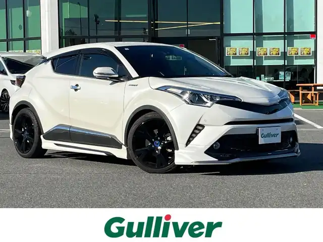 トヨタ Ｃ－ＨＲ ハイブリッド 1．8G 奈良県 2017(平29)年 5.6万km ホワイトパールクリスタルシャイン モデリスタフルエアロ/純正ナビ（NSZT-Y66T）/（フルセグ/BT/CD/DVD）/レーダークルーズコントロール/バックカメラ/ブラインドスポットモニター/プリクラッシュセーフティ/レーンキープアシスト/前後コーナーセンサー/ハーフレザーシート/前席シートヒーター/モデリスタ19インチAW/ETC2.0/前方ドライブレコーダー/取り扱い説明書/スペアキーX1