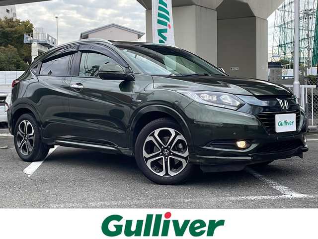 ホンダ ヴェゼル ハイブリッド Z 神奈川県 2014(平26)年 15.6万km ミスティックグリーンパール ワンオーナー/純正メモリナビ/・DTV/CD/DVD/BT/USB/HDMI/バックカメラ/レザーシート/前席シートヒーター/ビルトインETC/ルーフレール/クリアランスソナー/シティブレーキアクティブシステム/リアクティブフォースペダル/クルーズコントロール/車両接近通報装置/盗難防止装置/パドルシフト付き革巻きステアリング/純正17インチAW/オートライト/純正LEDヘッドライト/フォグランプ/アイドリングストップ/プッシュEgスタート/ストップ/スマートキー×2/ターンランプ付電動格納ドアミラー/ヒーテッドドアミラー/ドアバイザー/純正フロアマット/取扱説明書/新車時保証書