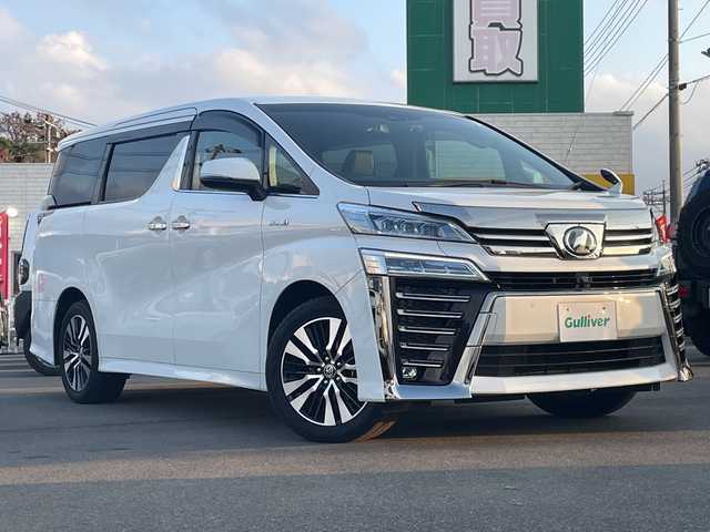 トヨタ ヴェルファイア ハイブリット ZR 山口県 2019(令1)年 2.6万km ホワイトパールクリスタルシャイン ＡＬＰＩＮＥ１１インチナビ　/AM/FM/CD/DVD/Bluetooth/フルセグTV/ＡＬＰＩＮＥ１２．８型フリップダウンモニター　/全方位カメラ　/両側パワースライドドア　/電動リアゲート　/黒革シート/シートベンチレーション/レーダークルーズコントロール　/前席、2列目パワーシート/三眼ＬＥＤヘッドライト　/クリアランスソナー/レーンキープアシスト/衝突被害軽減ブレーキ/純正１８インチアルミホイール/ＥＴＣ　/ドライブレコーダー