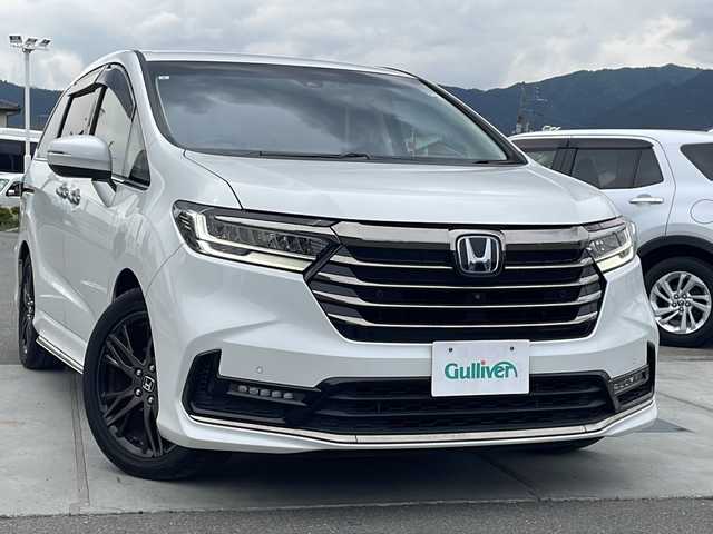 ホンダ オデッセイ ハイブリッド e:HEVアブソルート EX 山梨県 2021(令3)年 3.8万km プラチナホワイトパール フルセグテレビ/ホンダセンシング/両側パワースライドドア/純正10インチナビ/100V電源/衝突軽減装置/全周囲カメラ/前シートヒーター/パワーシート/オットマン/ETC/LEDヘッドライト/黒合革シート/ブラインドスポットモニター/オートマチックハイビーム/デュアルエアコン/革巻きステアリング