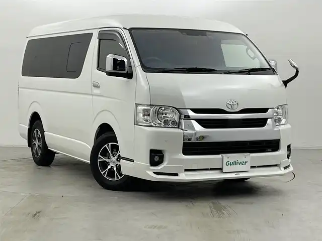 トヨタ ハイエース GL 群馬県 2023(令5)年 2.1万km ホワイトパールクリスタルシャイン パノラミックビューモニター/デジタルインナーミラー/パワースライドドア（挟み込み防止機能）/モデリスタエアロ/LEDヘッドライト/純正15インチアルミホイール/AC100V電源/純正フリップダウンモニター/純正7インチナビ（AM/FM/CD/DVD/SD/Bluetooth/フルセグTV）/片側パワースライドドア/トヨタセーフティセンス/プリクラッシュセーフティ/レーンディパーチャーアラート/オートマチックハイビーム/クリアランスソナー/パーキングサポートブレーキ/ステアリングスイッチ/純正ドライブレコーダー/純正ビルトインETC2.0/プッシュスタート/スマートキー