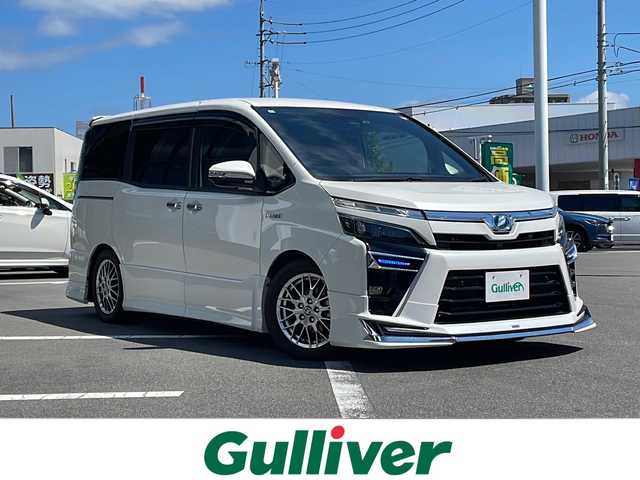 トヨタ ヴォクシー ハイブリッド ZS 煌Ⅱ 長野県 2020(令2)年 2.3万km ホワイトパールクリスタルシャイン トヨタセーフティーセンス/・プリクラッシュセーフティ/・レーンディパーチャーアラート/・オートマチックハイビーム/モデリスタエアロ（F・R）/車高調/純正10インチナビ【NSZN-Z68T】/（CD/DVD/BT/フルセグTV）/バックカメラ/ビルトインETC/両側パワースライドドア/クルーズコントロール/シートヒーター（D・N席）/ウッドコンビステアリング/ステアリングスイッチ/LEDヘッドライト/フォグランプ/オートライト/ドライブレコーダー/スマートキー/Pスタート/電動格納ミラー/純正１６インチAW