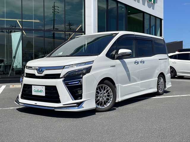 トヨタ ヴォクシー ハイブリッド ZS 煌Ⅱ 長野県 2020(令2)年 2.3万km ホワイトパールクリスタルシャイン トヨタセーフティーセンス/・プリクラッシュセーフティ/・レーンディパーチャーアラート/・オートマチックハイビーム/モデリスタエアロ（F・R）/車高調/純正10インチナビ【NSZN-Z68T】/（CD/DVD/BT/フルセグTV）/バックカメラ/ビルトインETC/両側パワースライドドア/クルーズコントロール/シートヒーター（D・N席）/ウッドコンビステアリング/ステアリングスイッチ/LEDヘッドライト/フォグランプ/オートライト/ドライブレコーダー/スマートキー/Pスタート/電動格納ミラー/純正１６インチAW