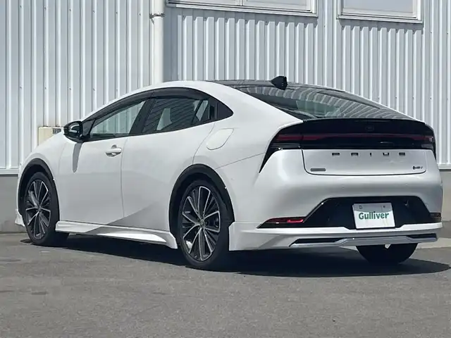 トヨタ プリウス Z 愛媛県 2024(令6)年 0.8万km プラチナホワイトパールマイカ 純正12.3インチディスプレイオーディオ/フルセグTV/Bluetooth　/全方位カメラ　/モデリスタエアロ/トヨタセーフティセンス/プリクラッシュセーフティ/レーダークルーズコントロール　/アドバンストパーク/緊急時操舵支援/車線逸脱防止装置/ブラインドスポットモニター/デジタルインナーミラー/D席シートメモリー機能/D/N席シートヒーター/シートベンチレーション　/ステアリングヒーター/パノラマルーフ　/電動トランクリッド　/純正ドライブレコーダー　/100Ｖ充電　/ワイヤレス充電　/ETC2.0/現状サマー(純正AW)(195/50/R19)/BRIDGESTONE ECOPIA