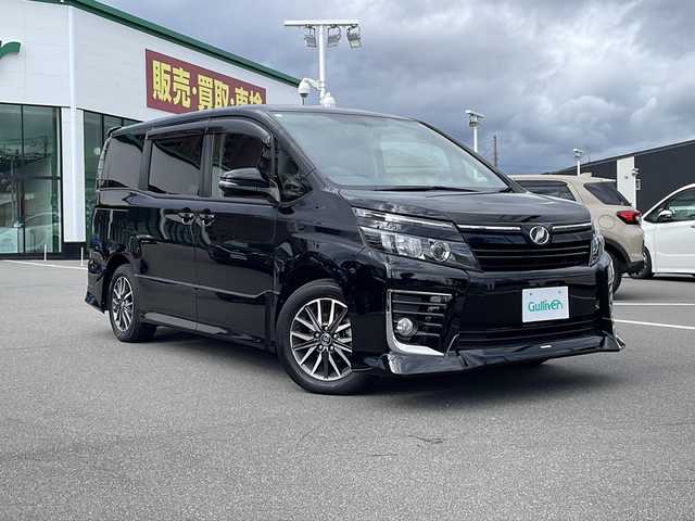 トヨタ ヴォクシー ZS 長野県 2014(平26)年 5万km ブラック TRDエアロ/純正9インチSDナビ（NSZT-Y64T）/FM・AM・DVD・CD・フルセグテレビ/Bluetooth Audio/ドライブレコーダー（YCD-18FHR）/両側パワースライドドア/レーダー探知機（YA-W17GA）/純正16インチアルミホイール/革巻きステアリング/アイドリングストップ/ステアリングスイッチ/LEDヘッドライト/オートライト/フォグランプ/純正フロアマット/ウィンカーミラー/ドアバイザー/プッシュスタート/スマートキー/ETC
