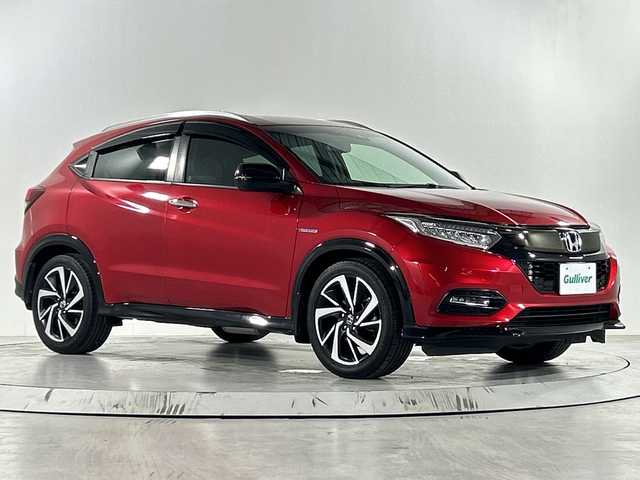 ホンダ ヴェゼル ハイブリッド RS ホンダセンシング 佐賀県 2018(平30)年 5.8万km プレミアムクリスタルレッドM 純正７型ナビ/(TV/CD/DVD/Bluetooth/SD録音/AM/FM)/衝突被害軽減システム/バックカメラ/コーナーセンサー/レーンキープアシスト/車線逸脱警報/レーダークルーズコントロール/パドルシフト/ハーフレザーシート/前席シートヒーター/純正アルミホイール/ＬＥＤヘッドライト/オートライト/フォグライト/純正フロアマット/ルーフレール/ドライブレコーダー/ビルトインETC/ドアバイザー/ステアリングリモコン/スマートキー/プッシュスタート/標識検知機能/横滑り防止装置/盗難防止装置
