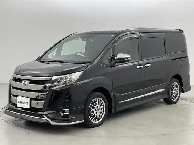 トヨタ ノア ハイブリッド Si ダブルバイビーⅢ 福岡県 2021(令3)年 2.7万km ブラック モデリスタエアロ／マフラーカッター　/後席モニター　/社外１１型ナビ　/前ドラレコ　/ＥＴＣ　/デジタルインナーミラー　/コーナーセンサー　/クルコン　/ＰＣＳ　/ＬＤＡ　/ＰＫＳＢ　/両側電動スライドドア　/シートヒーター