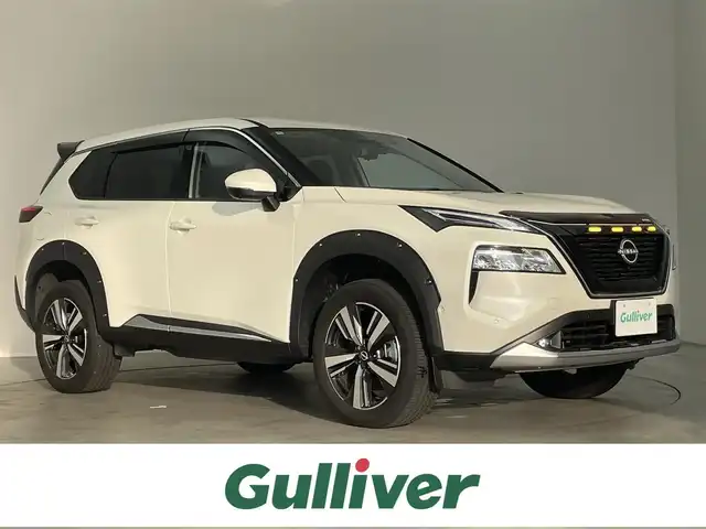 日産 エクストレイル G e－4ORCE 埼玉県 2024(令6)年 0.7万km ブリリアントホワイトパール BOSEオーディオ/アラウンドビューモニター/インテリジェントルームミラー/純正ナビ/フルセグTV/HUD/バグガード/オーバーフェンダー/リフトアップ/リアスポイラー/パワーシート/シートヒーター/シートメモリー/ハンドルヒーター/100v電源/LEDヘッドライト/19インチ純正アルミホイール/ETC2.0/BSM