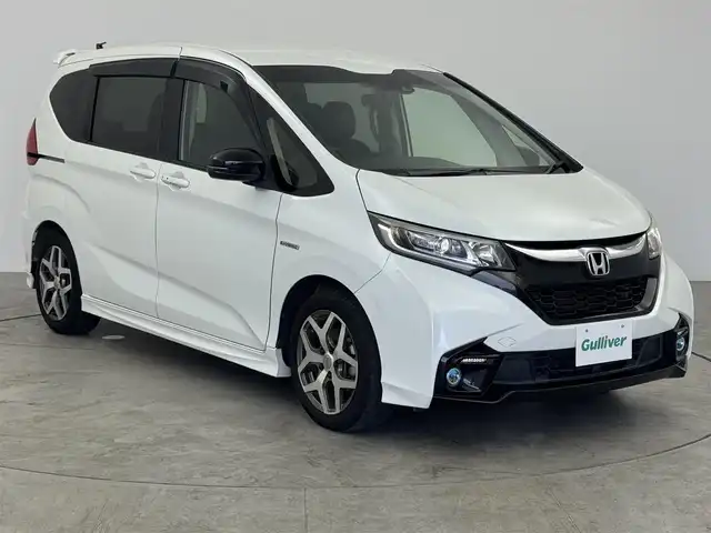 ホンダ フリード ハイブリット モデューロX ホンダセンシング 愛知県 2018(平30)年 7.1万km ホワイトオーキッドパール ホンダセンシング/　　・衝突軽減ブレーキシステム/　　・誤発進抑制機能/　　・歩行者事故低減ステアリング/　　・路外逸脱抑制機能/　　・アダプティブクルーズコントロール/　　・車線維持支援システム/純正7インチナビ　/　　・CD/DVD/BT/フルセグ/バックカメラ/ビルトインETC/革巻きステアリング/ステアリングリモコン/ハーフレザーシート/キャプテンシート/両側パワースライドドア/無限15インチアルミホイール/純正LEDヘッドライト/フォグランプ/取扱説明書/保証書