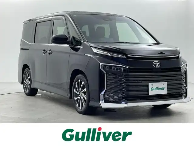 トヨタ ヴォクシー S－Z 福井県 2022(令4)年 1.4万km アティチュードブラックマイカ 純正10.5インチディスプレイオーディオ/（ナビ/Bluetooth/USB/Miracast/HDMI）/フルセグテレビ/バックカメラ/ETC/トヨタセーフティセンス/・プリクラッシュセーフティ/・レーンディパーチャーアラート/・オートマチックハイビーム/・ドライバー異常時対応システム/・発進遅れ告知機能/・レーントレーシングアシスト/・レーダークルーズコントロール/・ロードサインアシスト/・プロアクティブドライビングアシスト/・パーキングサポートブレーキ/オートブレーキホールド/ハーフレザーシート/シートヒーター/両側パワースライドドア/純正フロアマット/ステアリングスイッチ/革巻きステアリング/取扱説明書/保証書/スペアキー