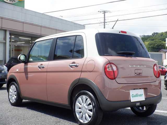 スズキ ラパン X 静岡県 2025(令7)年 0.1万km未満 テラコッタピンクメタリック/ソフトベージュ 2トーン  ワンオーナー(保証書あり）/ 走行：　4km(登録時)/ デュアルカメラブレーキサポート/ スマートキー ×2/ プッシュスタート/ 純正8インチナビ/ 全方位カメラ/ ビルトインETC/ 本革巻ステアリング/「ナノイーX」搭載フルオートエアコン/ 前席シートヒーター/ 純正14インチアルミ/ 純正LEDヘッドライト/ 純正フロアマット