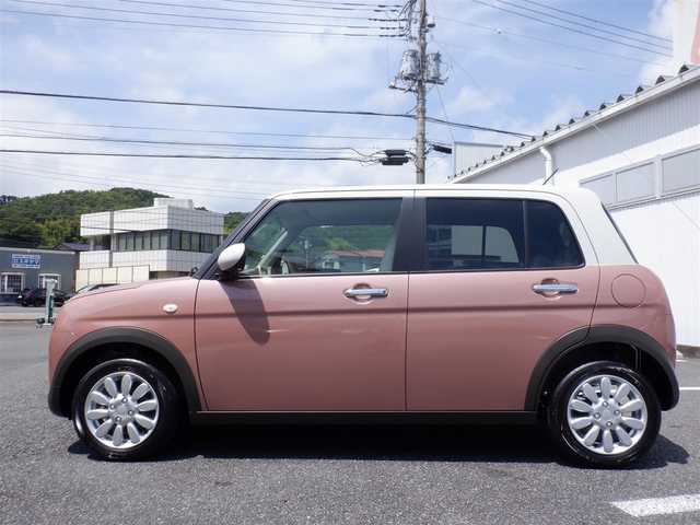 スズキ ラパン X 静岡県 2025(令7)年 0.1万km未満 テラコッタピンクメタリック/ソフトベージュ 2トーン  ワンオーナー(保証書あり）/ 走行：　4km(登録時)/ デュアルカメラブレーキサポート/ スマートキー ×2/ プッシュスタート/ 純正8インチナビ/ 全方位カメラ/ ビルトインETC/ 本革巻ステアリング/「ナノイーX」搭載フルオートエアコン/ 前席シートヒーター/ 純正14インチアルミ/ 純正LEDヘッドライト/ 純正フロアマット