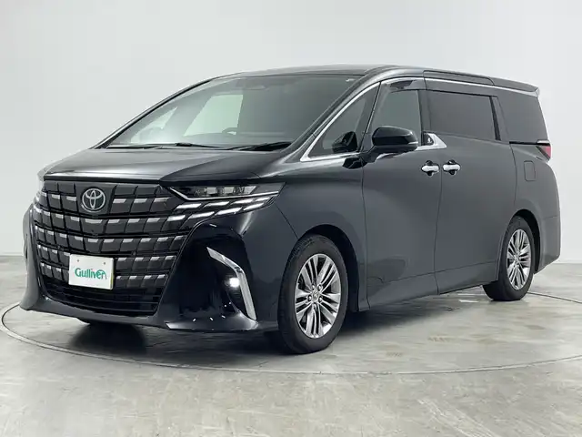 トヨタ アルファードハイブリット Z 群馬県 2024(令6)年 1.4万km ブラック ・トヨタ純正ナビ /・左右独立ムーンルーフ/・パノラミックビュー/・13.2型有機EL後席ディスプレイ/・デジタルインナーミラー/・両側パワースライドドア/・ETC2.0 /・レーダークルーズコントロール/・パワーバックドア/・ステアリングヒーター/・シートヒーター /・トヨタセーフティセンス/・BSM/・PSTA/・PKSB/・SRSエアバッグ（運転席/助手席/サイド/カーテン）/・純正１８インチアルミホイール/・LEDヘッドライト