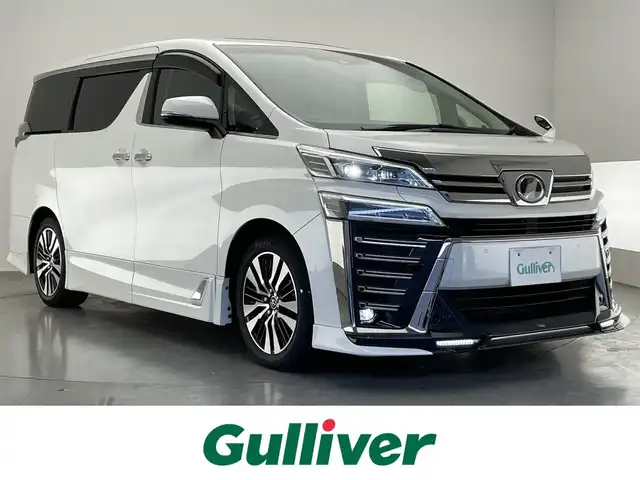 トヨタ ヴェルファイア Z Gエディション 愛知県 2018(平30)年 3.4万km ホワイトパールクリスタルシャイン 純10型SDナビ/フルセグTV/バックカメラ/TRDエアロパーツ/TRD4本出スポーツマフラー/ムーンルーフ/ETC2.0/ドラレコ/両側パワスラ/デジタルインナーミラー/BSM/パワーバックドア/黒レザー/エアシート/シートヒーター/TVキャンセラー/ハンドルヒーター/追従クルコン/LEDヘッドライト/オートハイビーム/フォグランプ/衝突軽減/カーテンエアバッグ/禁煙車/電子パーキング/ブレーキホールド