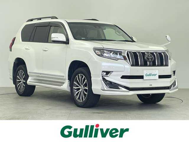 トヨタ ランドクルーザー プラド TX Lパッケージ 千葉県 2018(平30)年 4.3万km ホワイトパールクリスタルシャイン 7人乗り/サンルーフ/モデリスタエアロ/衝突軽減システム/社外後席モニター/レーンキープアシスト/レーダークルーズ/シートエアコン/コーナーセンサー/LEDヘッドライト/バックカメラ/ドライブレコーダー/ETC/オートハイビーム/パワーシート/レザーシート/ステリモ