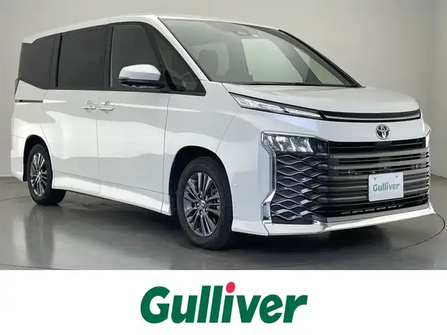 トヨタ ヴォクシー ハイブリッド S－G 愛知県 2023(令5)年 1.8万km ホワイトパールクリスタルシャイン 純正１０．５型ナビ　１４型後席モニター　トヨタチームメイト　禁煙　全方位カメラ　パーキングアシスト　ＢＳＭ　ＤＶＤデッキ　ユニバーサルステップ　電動リアゲート　快適利便Ｍｉｄ　衝突軽減　追従クルコンAC100V電源　クラッツイオシートカバー　LEDオートライト　オートハイビーム　アドバンスドパーク　コーナーセンサー