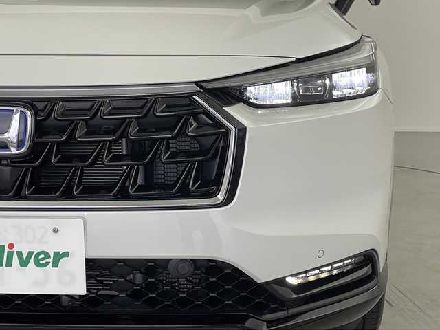 ホンダ ヴェゼル ハイブリッド e:HEV Z 岐阜県 2025(令7)年 0.1万km未満 プラチナホワイトパール Honda CONNECT 9インチディスプレーオーディオ/・ETC2.0車載器+ワイヤレス置くだけ充電器 (220000円)　/・Apple CarPlay/・Android Auto/・Bluetooth/・AM/FM/・USB/・車内WI-FI/フロントグリル　ベルリナブラック (41250円)/革巻きステアリング/・ハンドルヒーター/・ステアリングリモコン/・パドルシフト/スペアキー有/追従型クルーズコントロール/レーンキープアシスト/前後クリアランスソナー/電動パワーバックドア/ハーフレザーシート/・シートヒーター(D席/N席)/衝突軽減ブレーキ/・オートブレーキホールド/LEDヘッドライト/・オートライト/ダウンヒルアシストコントロール