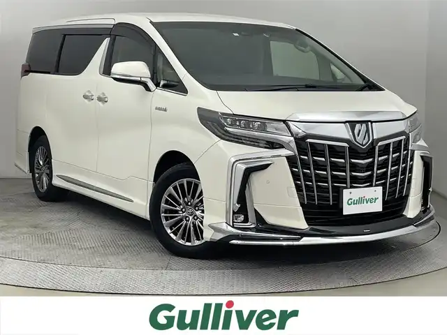 トヨタ アルファードハイブリット SR Cパッケージ 道央・札幌 2018(平30)年 6.3万km ラグジュアリーホワイトパールクリスタルシャインガラスフレーク ・４WD/・寒冷地仕様/・純正ナビ/　BT／CD／DVD／USB／SD／AUX／フルセグ/・全方位カメラ/・ビルトインETC2.0/・レーダークルーズコントロール/・前後コーナーセンサー/・レーンキープアシスト/・衝突軽減ブレーキ/・横滑り防止/・ブラインドスポットモニター/・デジタルインナーミラー/・両側パワースライドドア/・電動リアゲート/・前席シートヒーター/・運転席シートメモリー/・オットマン/・ステアリングヒーター/・JBLサウンド/・モデリスタエアロ/・LEDヘッドライト/・オートライト/・オートマチックハイビーム/・プッシュスタート/・スマートキー×2/・純正エンジンスターター/・純正フロアマット/・純正17インチAW