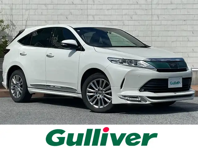 トヨタ ハリアー プレミアム 滋賀県 2018(平30)年 5.8万km ホワイトパールクリスタルシャイン 社外フロントエアロパーツ　TRD/純正9インチナビ　【NSZT-Y66T】/（AM/FM/CD/DVD/SD/フルセグ/Bluetooth）/ETC2.0/バックカメラ/ドライブレコーダー/運転席パワーシート/プリクラッシュブレーキアシスト/横滑り防止装置/レーダークルーズコントロール/レーンキープアシスト/クリアランスソナー/電動パーキングブレーキ/ブレーキホールド/電動リアゲート/電動格納ミラー/オートライト/オートマチックハイビーム/フロントフォグ/LEDヘッドライト/ウッドコンビステアリング/ステアリングスイッチ/純正フロアマット/ECOモード/PWRモード/プッシュスタート/スマートキー/スペアキー/フルオートエアコン