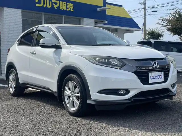 ホンダ ヴェゼル ハイブリッド X 徳島県 2014(平26)年 12.5万km ホワイトオーキッドパール (株)IDOMが運営する【じしゃロン徳島店】の自社ローン専用車両になりますこちらは現金またはオートローンご利用時の価格です。/自社ローンご希望の方は別途その旨お申付け下さい”										/社外ナビゲーション　/（フルセグ/CD/DVD/SD/BT)/衝突被害軽減ブレーキ　/バックモニター　/ＥＴＣ　/クルーズコントロール　/トラクションコントロール/スポーツモード切替/革巻きステアリング/電気式パーキングブレーキ/オートホールド/プッシュスタート　/スマートキー　/ＬＥＤヘッドライト　/フォグランプ/ウィンカーミラー/ステアリングリモコン/室内LEDランプ/カーテンエアバック　/純正フロアマット　/サイドバイザー