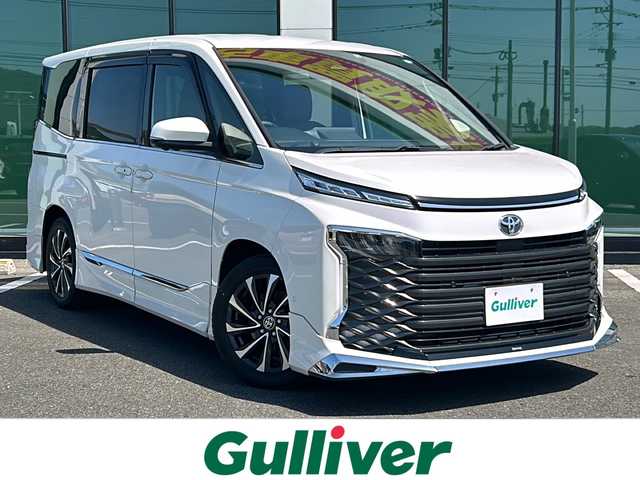 トヨタ ヴォクシー S－Z 愛知県 2022(令4)年 4.2万km ホワイトパールクリスタルシャイン モデリスタエアロ【フロント・サイド・リア】/純正8インチディスプレイオーディオ/【ナビ有/AM/FM/CD/DVD/Bluetooth/フルセグTV/Apple Car Play/Android Auto】/純正14インチフリップダウンモニター【V14T-R72R】/パノラミックビューモニター/ビルトインETC2.0/アドバンスドパーク/トヨタセーフティセンス/・オートマチックハイビーム/・プリクラッシュセーフティ/・レーントレーシングアシスト/・レーンディパーチャーアラート/・プロアクティブドライビングアシスト/リアカメラディテクション/パーキングサポートブレーキ/ロードサインアシスト/レーダークルーズコントロール/D席シートヒーター/WAC/カロッツェリア製茶色レザー調シートカバー/横滑り防止装置/盗難防止装置/保証書/取扱説明書/マルチメディア取扱説明書/スペアキー×1