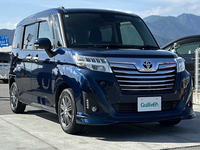 トヨタ ルーミー カスタムG－T 山梨県 2019(令1)年 1.6万km レーザーブルークリスタルシャイン 純正7インチナビ/Bluetooth接続/バックカメラ/衝突被害軽減システム/クルーズコントロール/両側パワースライドドア/ハンズフリーオートスライドドア/横滑り防止装置/純正ETC/ドライブレコーダー/アイドリングストップ/LEDヘッドライト/オートライト/オートハイビーム/社外14インチAW/純正AW付サマータイヤ/プッシュスタート/スマートキー/純正フロアマット/スペアキー/取扱説明書/保証書