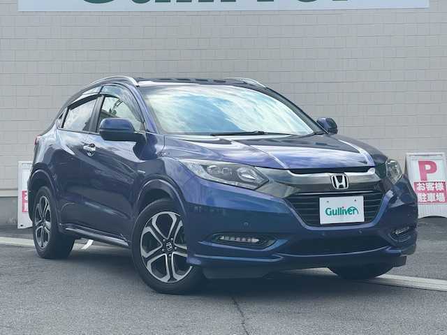 ホンダ ヴェゼル ハイブリッド Z ホンダセンシング 静岡県 2016(平28)年 5.9万km モルフォブルーP ●社外SDナビ/(フルセグ/CD/DVD/Bluetooth/iPod)/(ストラーダ/CN-AS300D)/●ハーフレザーシート/●前席シートヒーター/●バックカメラ/●アダプティブクルーズコントロール/●衝突被害軽減システム/●レーンキープアシスト/●前後パーキングセンサーシステム/●電動パーキングブレーキ/●オートブレーキホールド/●LEDヘッドライト＆フォグランプ/●オートライト/●革巻きステアリング/●ステアリングスイッチ/●ETC/●パドルシフト/●HDMI/●USB/●電動格納ウィンカーミラー/●ドアバイザー/●スマートキー/●プッシュスタート/●純正フロアマット/●純正17インチアルミホイール/●W＋サイド＋カーテンSRS＋ABS