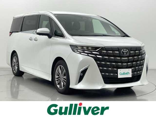 トヨタ アルファードハイブリット Z 熊本県 2024(令6)年 1.6万km プラチナホワイトパールマイカ ユニバーサルステップ　/純正ディスプレイオーディオ　/全周囲カメラ　/ビルトインETC2.0/純正13.2インチフリップダウンモニター　/社外前後ドライブレコーダー　/両側パワースライドドア　/前後クリアランスソナー　/トヨタセーフティーセンス/・プリクラッシュセーフティ/・レーンディパーチャーアラート/・オートマチックハイビーム/・レーダークルーズコントロール/・ドライバー異常対応システム/・ブラインドスポットモニター/横滑り防止/置くだけ充電/デジタルインナーミラー/パワーバックドア/前後クリアランスソナー/前席シートヒーター/ステアリングヒーター/前席エアーシート/全席パワーシート/2列目オットマン/純正フロアマット/純正１８インチAW/オートライト/LEDヘッドライト/フォグライト/スマートキー/プッシュスタート