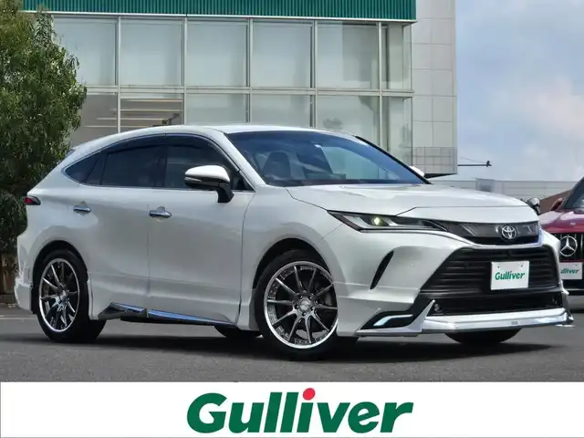 トヨタ ハリアー Z レザーパッケージ 鹿児島県 2020(令2)年 1.1万km ホワイトパールクリスタルシャイン モデリスタエアロ　/社外テール／ブレーキランプ（ネクサスジャパン製）　/社外ダウンサス（ＲＳＲ製Ｔｉ２０００）/社外アルミホイール(Weds/MAVERICK/20インチ)/デジタルインナーミラー　/パノラミックビューモニター　/ＪＢＬプレミアムサウンドシステム/D+N席シートヒーター/D+N席シートベンチレーション/D+N席パワーシート/純正メモリーナビ/Bluetoothオーディオ/パワーバックドア/レーダークルーズコントロール/横滑り防止装置/レーンキープアシスト/前後コーナーセンサー/トヨタセーフティセンス/プッシュスタート/スマートキー/ワンオーナー/純正アルミホイール(18インチ)