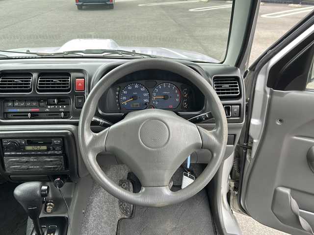 スズキ ジムニー XG 岐阜県 2001(平13)年 15.8万km シルキーシルバーメタリック 登録時走行距離157387km/ルーフレール/背面タイヤ/オーディオ/リモコンキー/布系シート/フルフラットシート/純正フロアマット/エアコン/ハロゲンヘッドライト/エアバッグ運転席・助手席/パワーウィンドウ／パワーステアリング