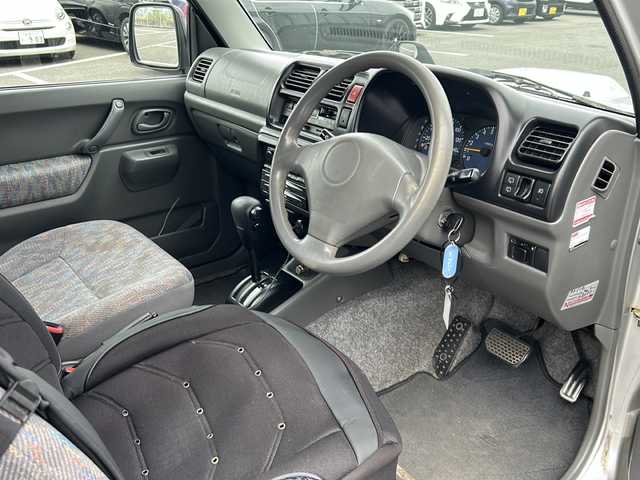 スズキ ジムニー XG 岐阜県 2001(平13)年 15.8万km シルキーシルバーメタリック 登録時走行距離157387km/ルーフレール/背面タイヤ/オーディオ/リモコンキー/布系シート/フルフラットシート/純正フロアマット/エアコン/ハロゲンヘッドライト/エアバッグ運転席・助手席/パワーウィンドウ／パワーステアリング