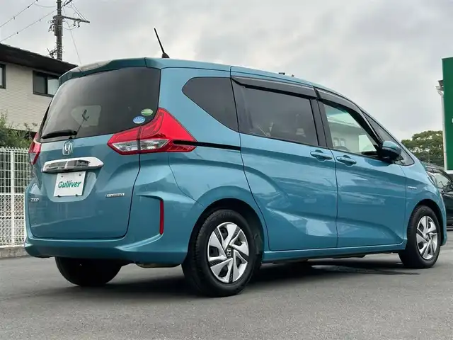 ホンダ フリード ハイブリット G ホンダセンシング 静岡県 2018(平30)年 5.7万km ブルーホライゾンM エンジンスタートボタン/パワーステアリング/パワーウィンドウ/寒冷地仕様/アイドリングストップ/スマートキー/オートエアコン/クルーズコントロール/純正ETC/バックカメラ/純正メモリナビ（CD/BT/ワンセグ）/ドライブレコーダー/3列シート/ウォークスルー/純正フロアマット/両側パワースライドドア/純正アルミホイール/ABS/横滑り防止装置/レーンキープアシスト/オートライト/LEDヘッドライト/Wエアバック/衝突軽減システム