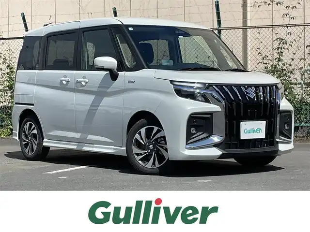 スズキ ソリオ バンディット HV MV 東京都 2025(令7)年 0.4万km ピュアホワイトP ワンオーナー　/ヘッドアップディスプレィ　/ブラインドスポットモニター　/純正ＬＥＤヘッドライト　/セーフティサポート /（予防安全技術）/・デュアルセンサーブレーキサポート２/・後方誤発進抑制機能/・誤発進抑制機能/・低速時ブレーキサポート/・パーキングセンサー/・全車速追従機能停止保持機能付クルーズコントロール　/・発進お知らせ機能/・ハイビームアシスト/・車線逸脱警報/両側パワースライドドア/プッシュエンジンスタート/パーソナルテーブル/・ロールサンシェード/保証書＆取説