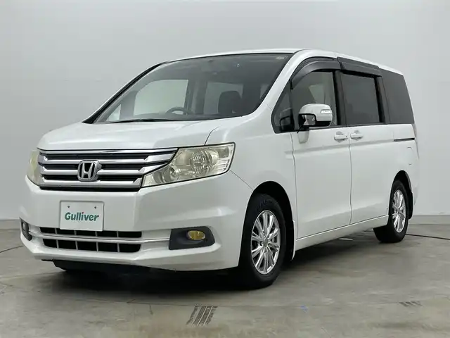 ホンダ ステップワゴン G Eセレクション 岡山県 2013(平25)年 7.3万km ホワイトオーキッドパール フリップダウンモニター/型番:VM-108N/純正９インチナビ/【CD/DVD/フルセグTV】/型番:VXM-135VFNi/バックカメラ/両側パワースライドドア/社外ドライブレコーダー（前後）/ビルトインＥＴＣ/アイドリングストップ/LEORIS15インチアルミホイール/純正フロアマット/フォグランプ/スマートキー×1