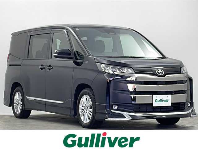 トヨタ ノア S－G 大阪府 2024(令6)年 2.4万km アティチュードブラックマイカ モデリスタエアロ/純正10.5型ディスプレイオーディオナビ/【フルセグTV/AM/FM/CD/DVD/BT/USB/HDMI】/快適利便パッケージ(mid)/・ハンズフリーパワースライドドア/・左右独立フロント＋リアエアコン/・D/N席シートヒーター/・独立センターコンソール/・nanoe/TVキャンセラー/バックカメラ/両側パワースライドドア/ToyotaSafetySense/・プリクラッシュセーフティ/・レーントレーシングアシスト＋レーンディパーチャーアラート/・レーダークルーズコントロール/・アダプティブハイビームシステム/・ロードサインアシスト/・ドライバー異常時対応システム/・プロアクティブドライビングアシスト/・発進遅れ告知機能/パーキングサポートブレーキ/車両接近通報装置/アイドリングストップ/オートホールド/ビルトインETC2.0/WAC/後席サンシェード/純正16インチAW/純正フロアマット/スマートキー/サマータイヤ積込み