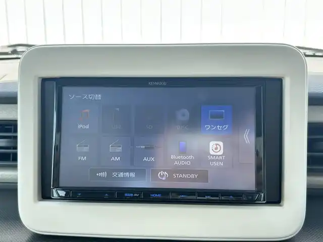 スズキ ラパン G 群馬県 2021(令3)年 0.6万km フォーンベージュM 社外ナビ/　AM/FM/BT/TV/AUX/CD/SD/USB/衝突軽減ブレーキ/レーンキープアシスト/コーナーセンサー/横滑り防止機能/アイドリングストップ/前方ドライブレコーダー/AUTOライト/運転席側シートヒーター/純正フロアマット/純正ドアバイザー/プッシュスタート/保証書/取扱説明書/スペアキー1