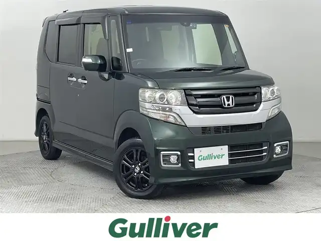 ホンダ Ｎ ＢＯＸ カスタム SSブラックSパッケージ 道央・札幌 2017(平29)年 4.9万km ブリティッシュグリーンP ・４WD/・寒冷地仕様/・純正メモリナビ/　BT／USB／CD／DVD／SD／iPod／AUX／フルセグ/・純正ビルトインETC/・社外前後ドライブレコーダー/・バックカメラ/・衝突軽減ブレーキ/・シティブレーキアクティブシステム/・横滑り防止/・両側パワースライドドア/・前席シートヒーター/・純正サマー14インチAW/・純正フロアマット/・ベンチシート/・オートライト/・プッシュスタート/・スマートキー