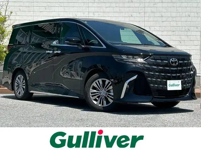 トヨタ アルファード Z 滋賀県 2024(令6)年 1.5万km ブラック ガソリン/2WD(FF)/CVT/左右独立ムーンルーフ/両側パワースライドドア/１４インチ純正コネクティッドナビ/(FM/AM/USB/HDMI/フルセグ/Bluetooth)/ETC2.0/前後ドライブレコーダー/パノラミックビューモニター/バックカメラ/ＴＶキャンセラー/後席用サイドサンシェード/ＴｏｙｏｔａＳａｆｅｔｙＳｅｎｓｅ/・踏み間違い防止アシスト	/・ブレーキアシスト	/・プリクラッシュブレーキアシスト	/・プロアクティブドライビングアシスト/・ブラインドスポットモニター/・安心降車アシスト/・レーンキープアシスト	/・レーダークルーズコントロール/・標識検知機能	/全席シートヒーター/全席シートベンチレーション/ワイヤレス充電/電動格納ミラー/電動リアゲート/電動パーキング/ブレーキホールド/革巻きステアリング/ステアリングスイッチ/ステアリングヒーター/オートライト/LEDヘッドライト/フロントフォグ/リアフォグ/オートマチックハイビーム/フルオートエアコン/プッシュスタート/スマートキー/スペアキー/社外フロアマット/ヘッドアップディスプレイ