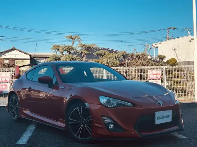 トヨタ ８６ GT 静岡県 2012(平24)年 9.5万km オレンジメタリック ユーザー買取車両/純正HDDナビ（NHZA-W61G）/【AM/FM/CD/BT/TV】/純正17インチAW/MTモード付AT/パドルシフト/スマートキー/エンジンスタートボタン/バックカメラ/ETC/レザーシート/純正エアロパーツ（フロント、サイド、リア）/横滑り防止装置/ドライブレコーダー/保証書/取扱説明書