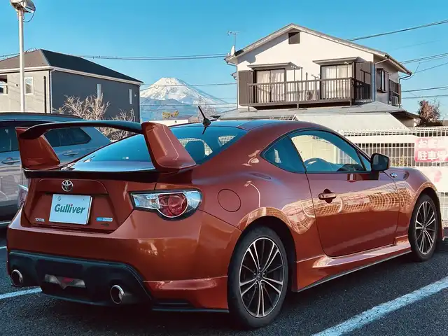 トヨタ ８６ GT 静岡県 2012(平24)年 9.5万km オレンジメタリック ユーザー買取車両/純正HDDナビ（NHZA-W61G）/【AM/FM/CD/BT/TV】/純正17インチAW/MTモード付AT/パドルシフト/スマートキー/エンジンスタートボタン/バックカメラ/ETC/レザーシート/純正エアロパーツ（フロント、サイド、リア）/横滑り防止装置/ドライブレコーダー/保証書/取扱説明書